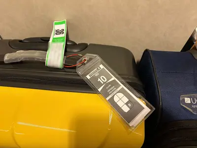 Both luggage tags on the suitcase