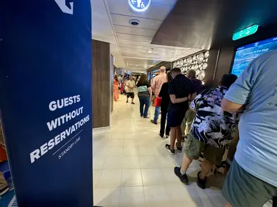 Guests without a reservation wait in a long line for dinner