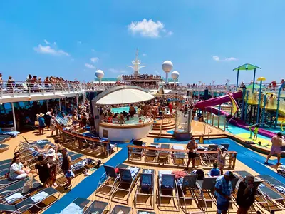 Pool deck with hot tubs and kids splash pad on Adventure of the Seas