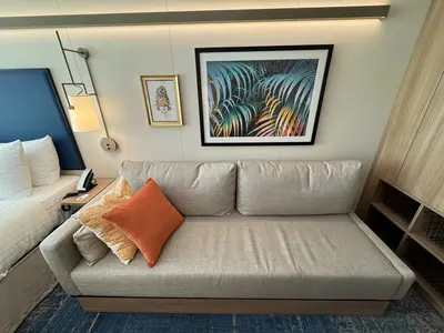 Spacious Infinite Central Park Balcony Cabin couch on Icon of the Seas
