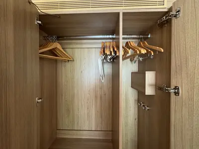 Open closet in the Spacious Infinite Central Park Balcony Cabin on Icon of the Seas