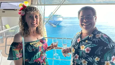 two people smiling during sailaway from cruise ship