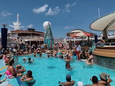 Voyager of the Seas pool deck with a bar, pool and hot tub
