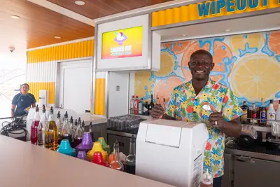 crew member smiling at the shaved ice station