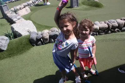 Kids playing mini golf