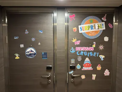 Two decorated cruise cabin doors on Quantum of the Seas 