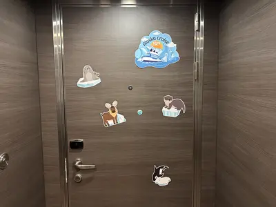 Decorated stateroom door on Quantum of the Seas featuring Alaska-themed magnets