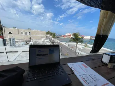 Using a laptop at a restaurant in Cozumel