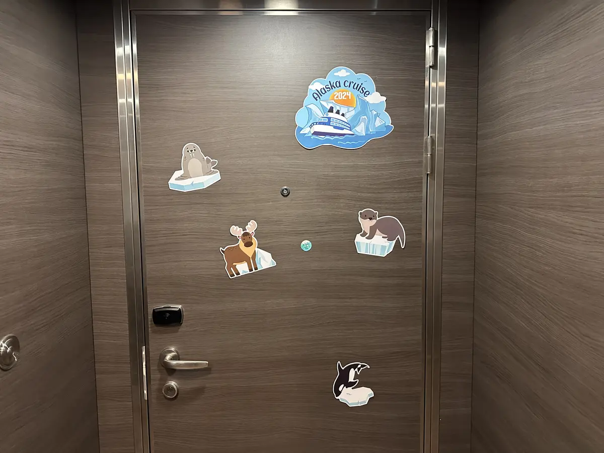 Cruise-Cabin-Decor-Quantum-4 Decorated stateroom door on Quantum of the Seas featuring Alaska-themed magnets