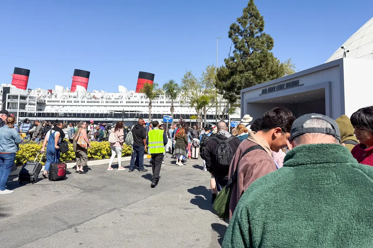 a long line to board Carnival Firenze at the Long Beach cruise terminal