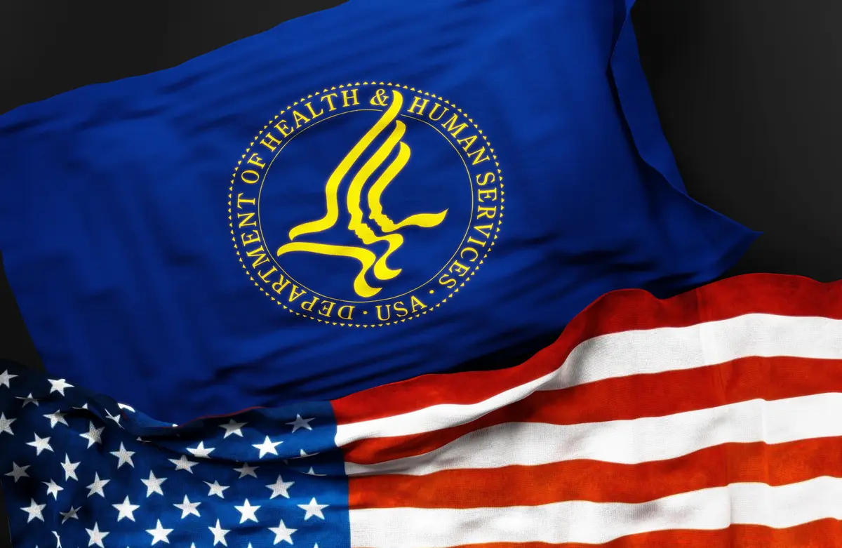 United States Department of Health and Human Services along with a flag of the United States of America