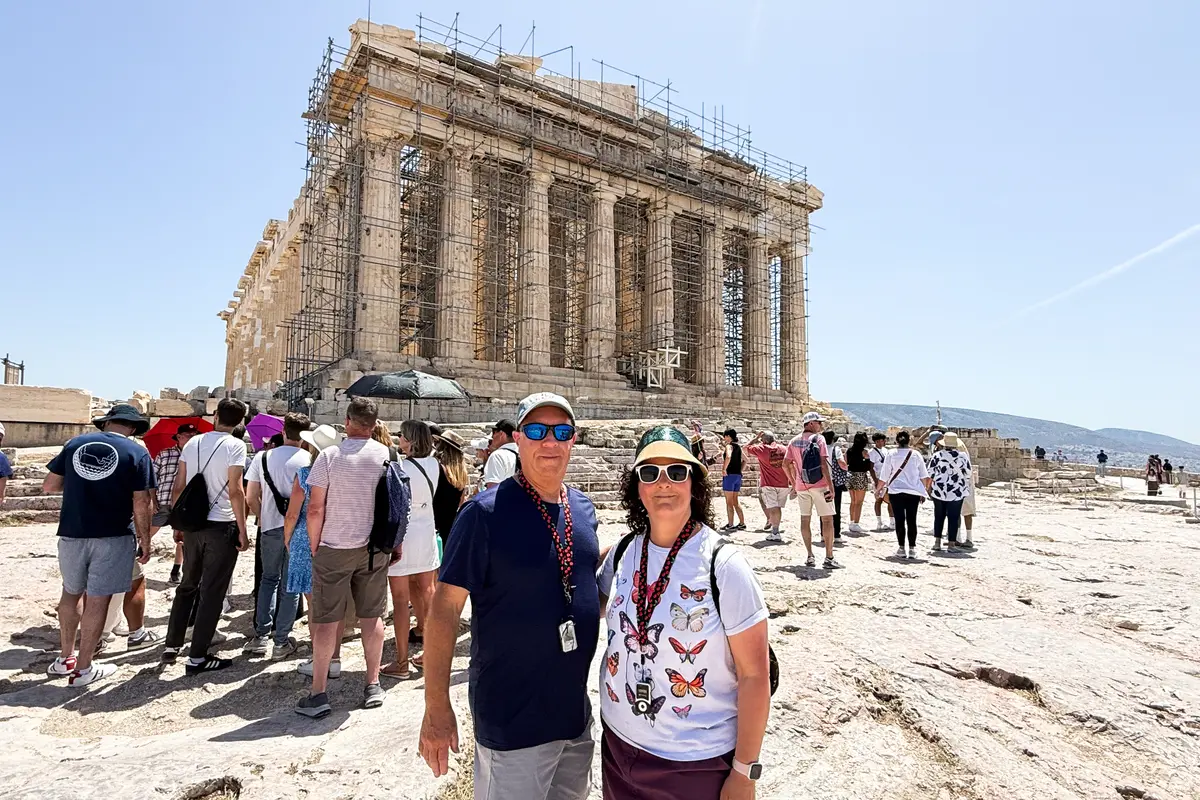 Jenna's parents smiling at the Acropolis in Athens