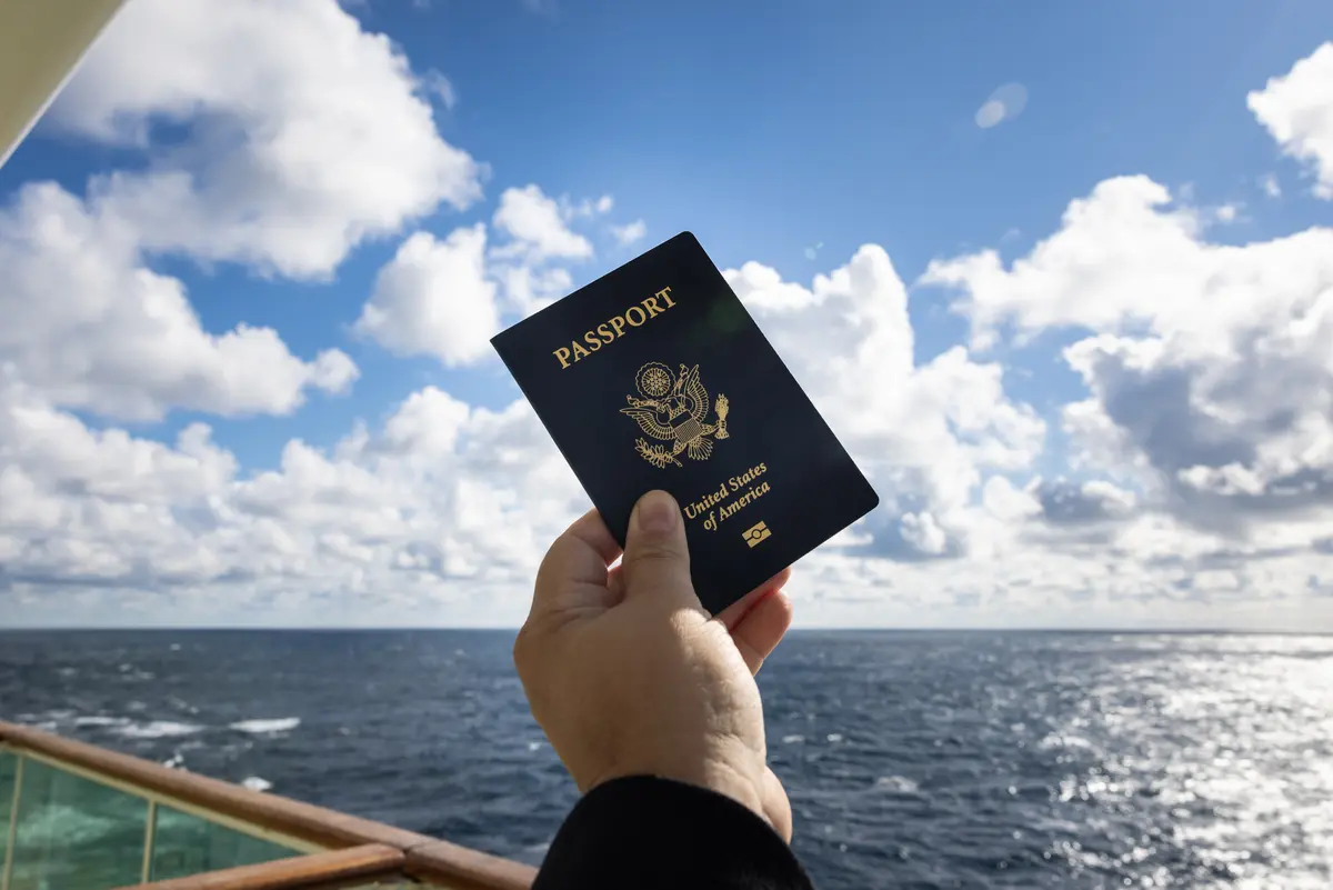 hand holding up an United States of America Passport