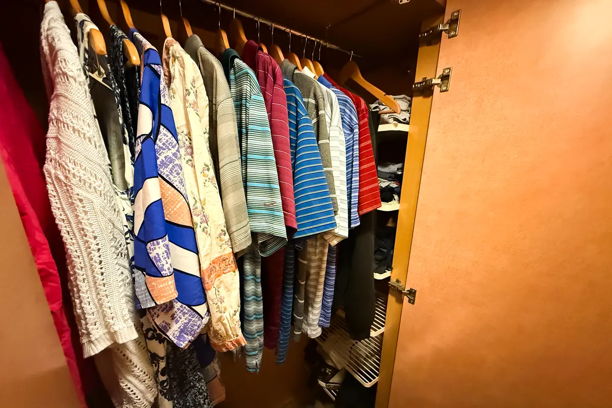 Clothes unpacked into a closet on a cruise ship
