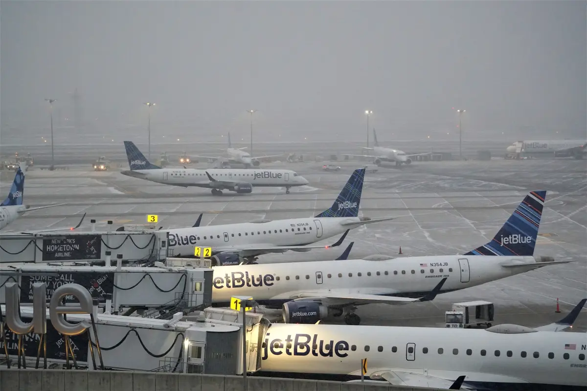 JetBlue airplanes at gates during snowstorm