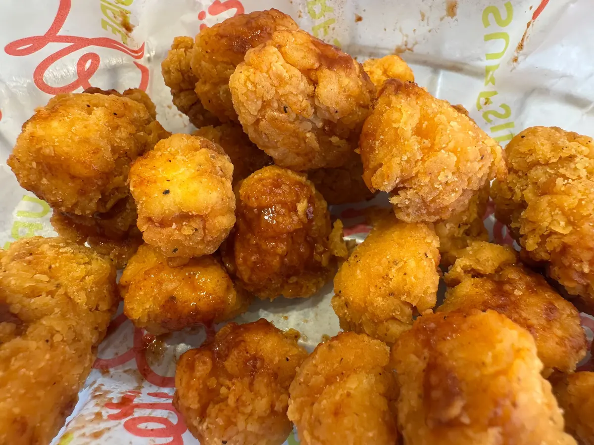 Popcorn chicken covered in hot sauce