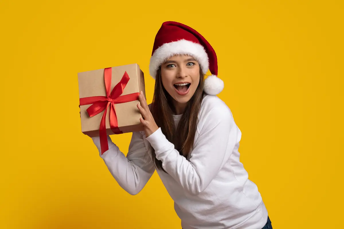 Girl in Christmas Hat Holding a Gift